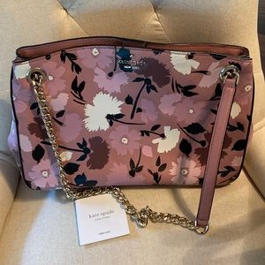 Kate Spade leather handbag with flower print. Gold chain and leather handles.